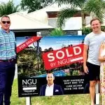 ANOTHER SALE: Kurt Cockburn from NGU with a family who recently sold in the Springfield district.