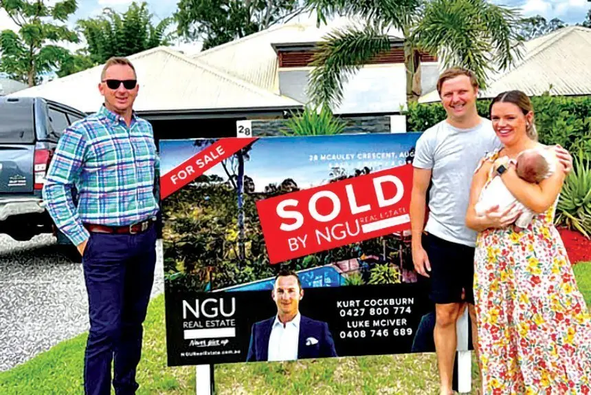 ANOTHER SALE: Kurt Cockburn from NGU with a family who recently sold in the Springfield district.