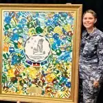 TALENTED ARTIST: Indigenous Liaison Officer, Flight Lieutenant Aimee McCartney with one of her recent artworks.