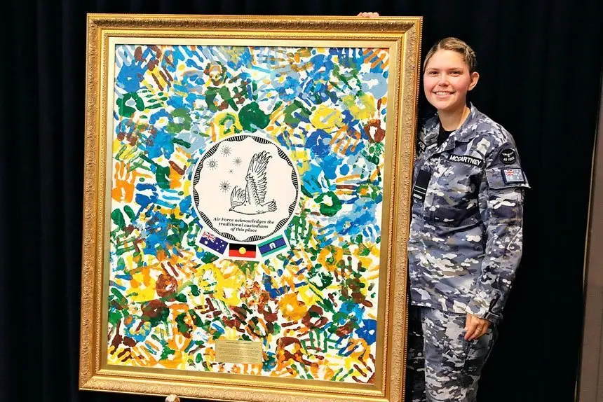 TALENTED ARTIST: Indigenous Liaison Officer, Flight Lieutenant Aimee McCartney with one of her recent artworks.
