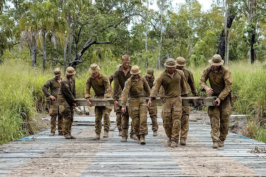 READY TO BLOW: Australian Army sappers from the 2nd Combat Engineer Regiment remove timber planks from Elanora Bridge to lay high explosive charge in preparation for demolition during Exercise Terrier Walk at Shoalwater Bay Training Area, Queensland.