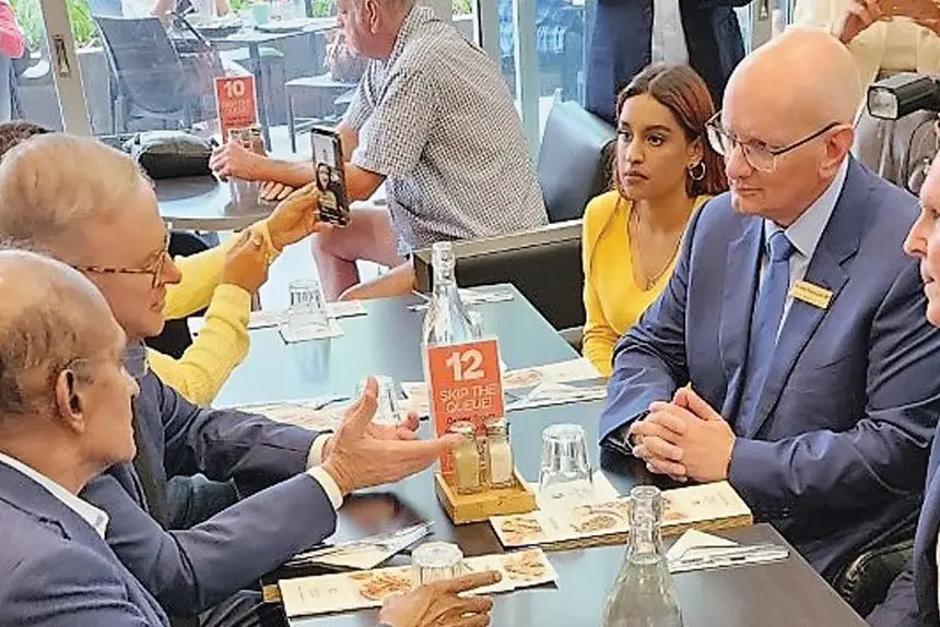 EAR OF THE PM: Maha Sinnathamby, Shayne Neumann and Bob Sharpless with PM Albanese at Orion Shopping Centre.