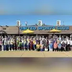 READY TO ROLL: Players from 16 different clubs who attended the Fours Carnival line up for a group shot before sending down the first bowl.