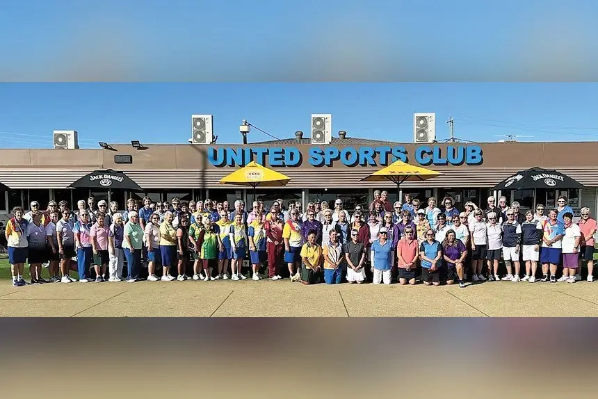 READY TO ROLL: Players from 16 different clubs who attended the Fours Carnival line up for a group shot before sending down the first bowl.