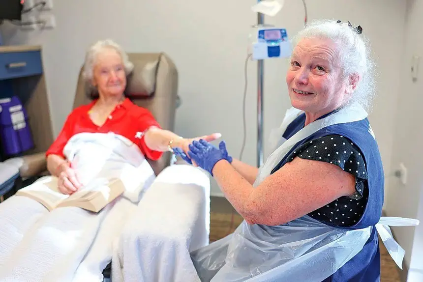 CARING: Pamela Hirst with cancer patient Valmai McDonald, 92, from Ipswich. Photo Peter Wallis