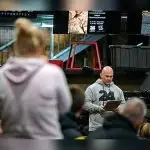 Warrant Officer Class 2 Beau Thomas reads the biography of a fallen soldier before the workout begins at the fundraiser for Wounded Heroes. Photo: TrewBella Photography