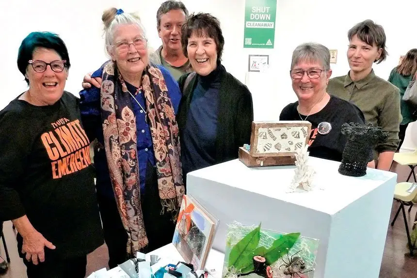 Guests at the ‘Swich to Green’ Art Exhibition looking over the entries.