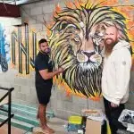 BOXING ARTIST: Luke Montgomery with boxing coach Suli Kurene who is also a talented artist. Suli was adding some character to the new gym.
