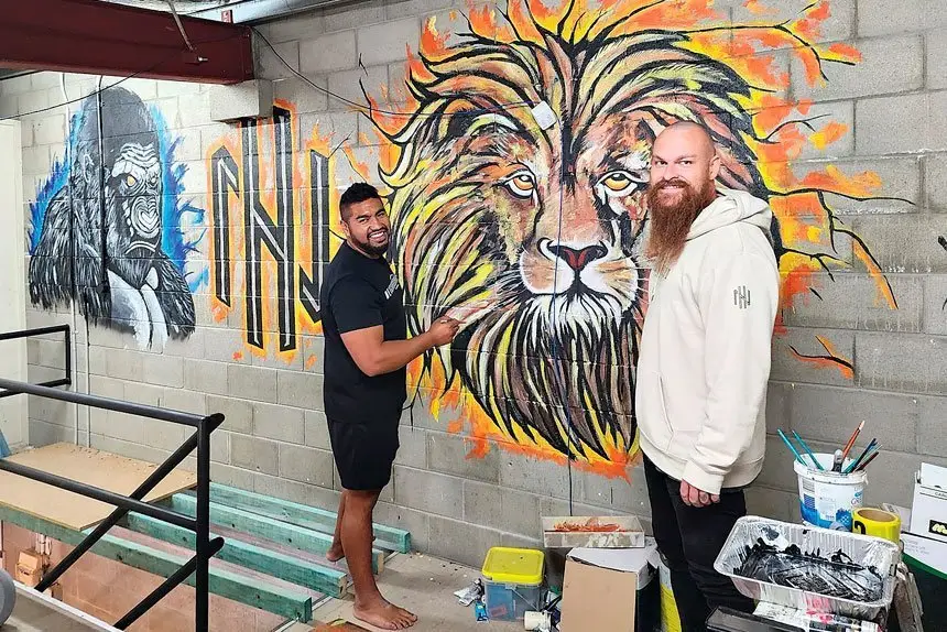 BOXING ARTIST: Luke Montgomery with boxing coach Suli Kurene who is also a talented artist. Suli was adding some character to the new gym.