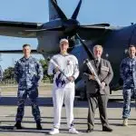 PHOTO: Legacy Centenary Torch Relay Bearer Nicholas Paske and Chairman of Legacy Australia, Eric Easterbrook (Centre) with Royal Australian Air Force personnel at RAAF Base Amberley