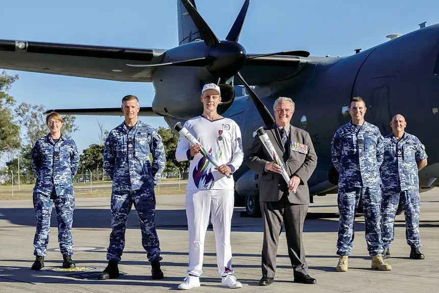 PHOTO: Legacy Centenary Torch Relay Bearer Nicholas Paske and Chairman of Legacy Australia, Eric Easterbrook (Centre) with Royal Australian Air Force personnel at RAAF Base Amberley