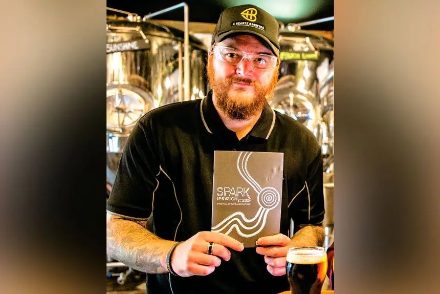 HERE’S CHEERS: Hearts Brewing master brewer Reece Richards with the Ipswich Light vat in the background.