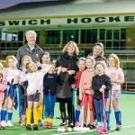 GOOD NEWS: Jennifer Howard pulling faces with the kids at the soon to be replaced main pitch at the Ipswich hockey centre.