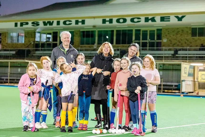 GOOD NEWS: Jennifer Howard pulling faces with the kids at the soon to be replaced main pitch at the Ipswich hockey centre.