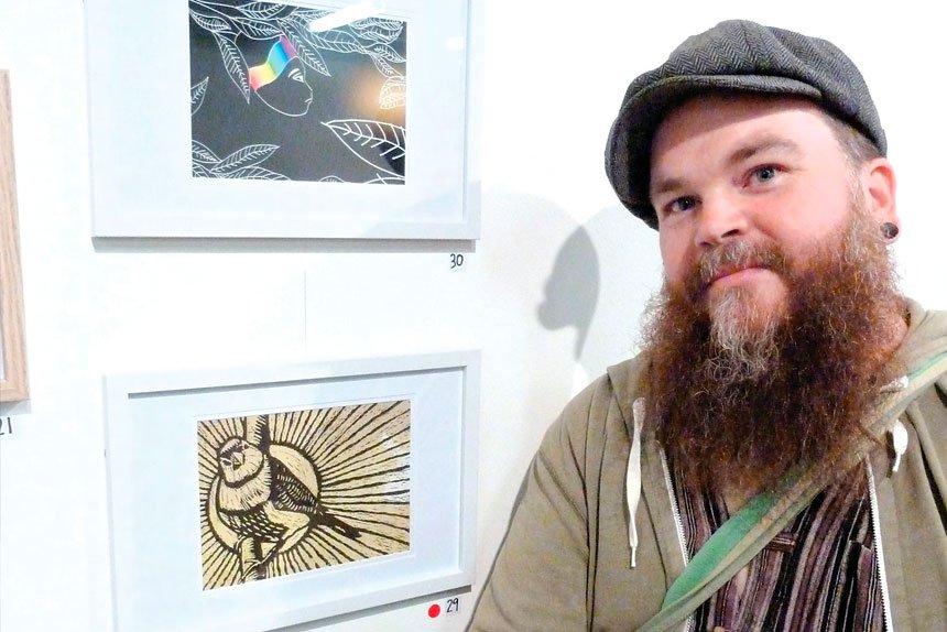 Artist Justin Leewater with ‘Double Barred Finch with his artwork that won second place at the ‘Swich to Green’ Postcard Competition. 