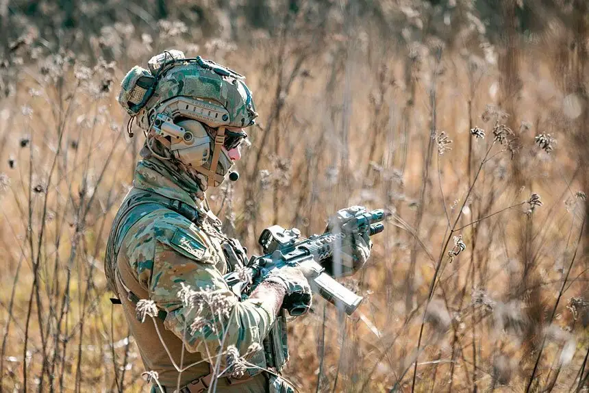 A Royal Australian Air Force combat controller, from 4 Squadron, patrols during a training serial, as part of Exercise Teak Action.  
