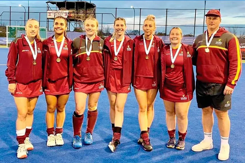 CHAMPIONS: Ipswich hockey players celebrate their gold medal win.