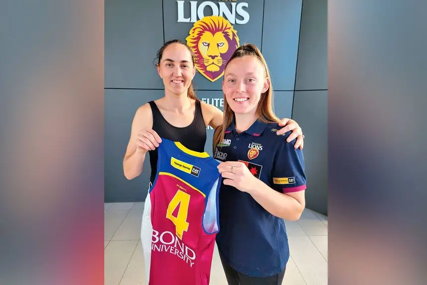 LOOK AFTER THIS: Retiring foundation Lion, Sharnie Webb, hands over her number four jersey to 19 -year-old Caitlin Wendland. 