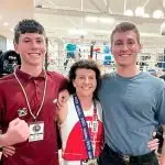 MUM PACKS A PUNCH: Kim Bennett celebrates her title win with her sons, Joe and Jeff