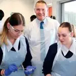 OUR FUTURE: Bellbird Park’s executive principal, Michael West, drops into a science class to speak with students Tah-lia Prazerers and Ella Horner
