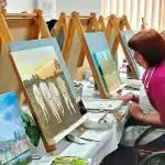 PREPARING: Students at U3A getting works ready to show.