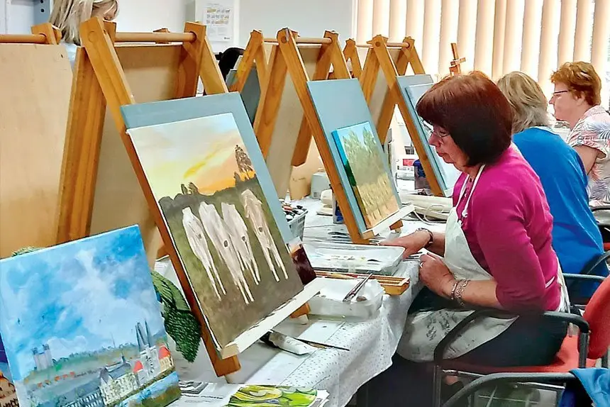 PREPARING: Students at U3A getting works ready to show.