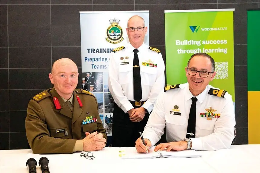 READY TO TRAIN: Brigadier Glenn Ryan and Commodore John Stavridis sign the Joint Technical Trades and Training Services contract with Captain Scott Houlhan as witness at the Australian Defence Force Academy in Canberra.