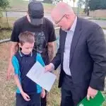 YOUR ONLINE: Shayne Neumann presents the Schroeder family with a voucher providing free internet access for a year under the Albanese Government’s School Student Broadband Initiative.