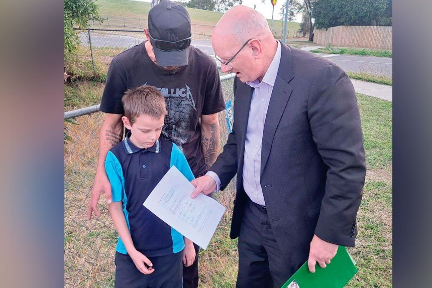 YOUR ONLINE: Shayne Neumann presents the Schroeder family with a voucher providing free internet access for a year under the Albanese Government’s School Student Broadband Initiative.