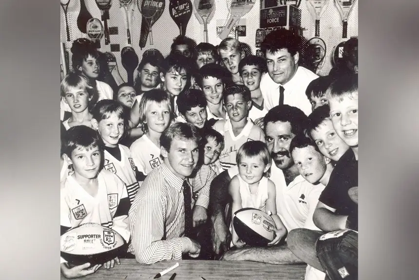 FOOTY HERO: Allan Langer and Sam Backo meet the fans. Getting Langer’s signature was always big for the fans.