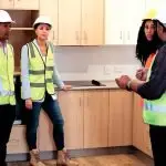 NEARLY FINISHED: Bundamba State MP, Lance McCallum, Minister Scanlon and YWCA’s Charlotte Dillon inspect the kitchen in one of the almost completed units at Goodna.
