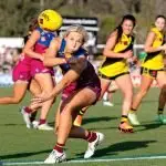 QUICK DISPOSAL: Charlotte Mullins of the Lions handpasses to a team-mate during the opening round clash with the Richmond Tigers.