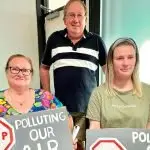 STINK PROTESTORS: Some carried signs into the recent Ipswich Stink meeting.
