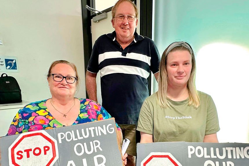 STINK PROTESTORS: Some carried signs into the recent Ipswich Stink meeting.