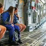 WORLD BELOW: Bremer State High School, Ipswich, Indigenous students Harmony Shaddick, Arielle Wilson and Koda Sheather flying in a No. 26 Squadron C-17 Globemaster III on a NAIDOC familiarisation flight from RAAF Base Amberley.