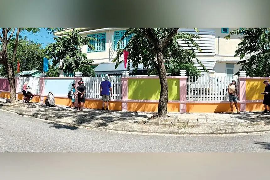 NEW FENCE: Simple things such as painting the local school’s dilapidated fence brings hope to a poor country village.