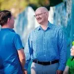 WE CAN HELP: Shayne Neumann talks to a local family about the home grants opportunities.