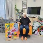 Jack Ryan with his colourful artworks.
