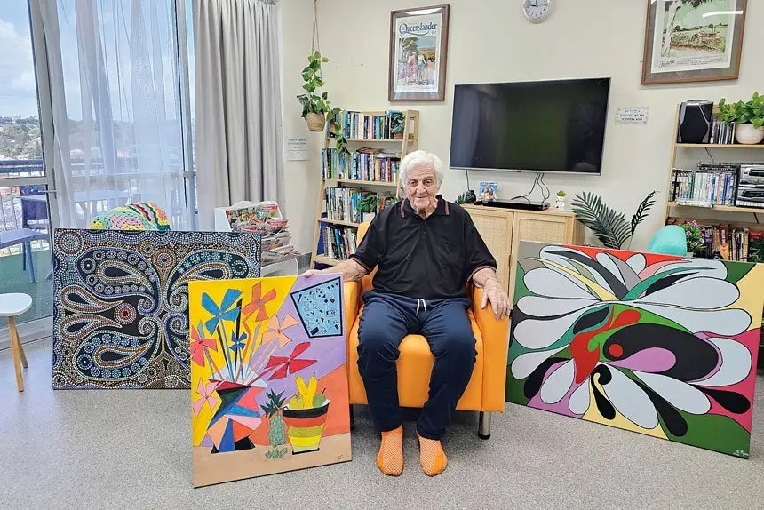 Jack Ryan with his colourful artworks.