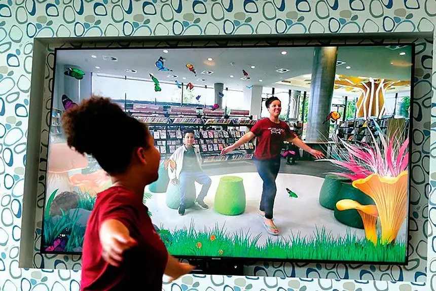 MAGICAL MOMENT: Deondre Huff, 8, and Mahailiyah Huff, 12, enjoy the butterfly experience.