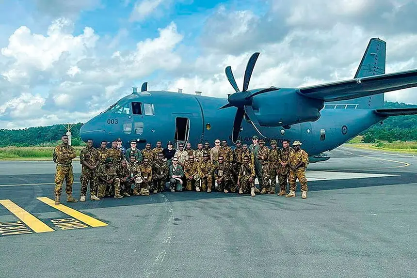 READY TO ROLL: No. 35 Squadron members from the first air mobility detachment with Papua New Guinea Defence Force personnel, stand with a C-27J Spartan at Wewak Airfield, Papua New Guinea.