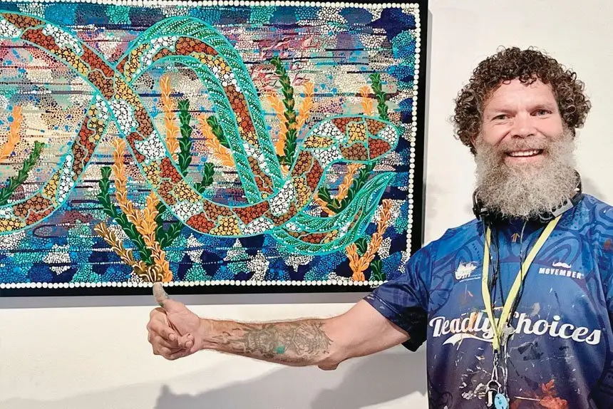 Tallman shows off some of his distinctive artwork.