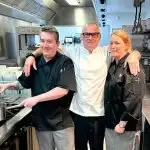 TASTY TEAM: Neil Smith (centre) cooks up magnificent munchies with members of his catering crew Kieran Smith and Chrissie Voll, with whom he shares credit for his success.