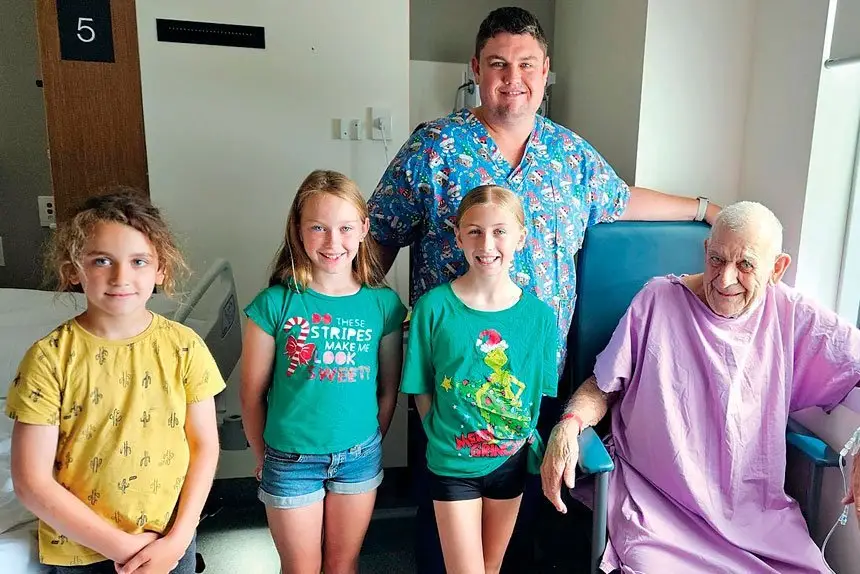 Luke with his three daughters and a patient during the EWE program.