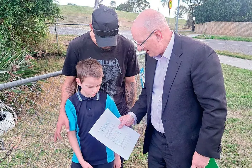Federal Member for Blair Shayne Neumann presents the Schroeder family from Ipswich with a voucher providing free internet access for a year under the Albanese Government’s School Student Broadband Initiative.