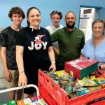 Westside Community Care coordinator Nohblee Gottani and volunteers sorting through the pantry of supplies PHOTO: Westside Community Care
