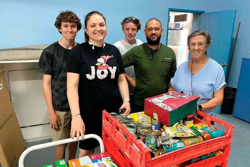 Westside Community Care coordinator Nohblee Gottani and volunteers sorting through the pantry of supplies PHOTO: Westside Community Care