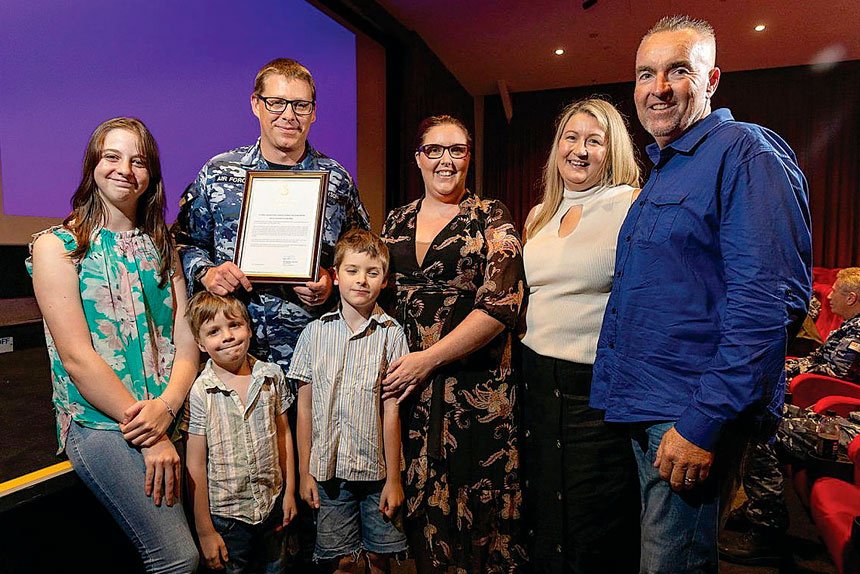 Air Force Leading Aircraftman Thomas Finlayson with his family after being awarded a Gold Commendation at RAAF Base Richmond, for providing first aid assistance to Mr Jeff Goodwin (right) during a cricket game.