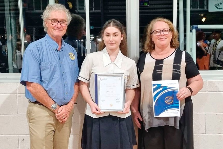 Award winner T’Schani Falwasser receiving recognition from Chris Steinback and Sandra Goss.