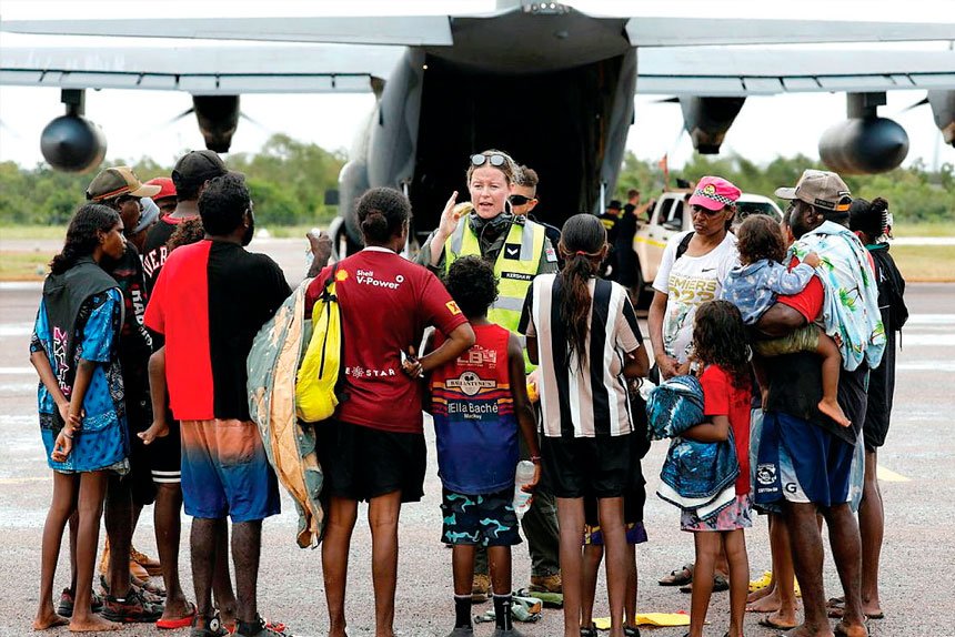 Air Force aviator Corporal Kate Kershaw, of 37 Squadron, delivers a pre-flight safety brief to residents of Borroloola prior to evacuation to Darwin.